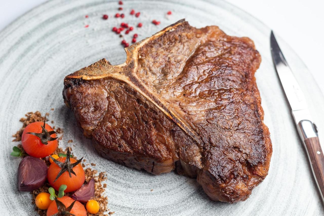 Doubletree By Hilton Minsk Hotel Bagian luar foto A cooked steak